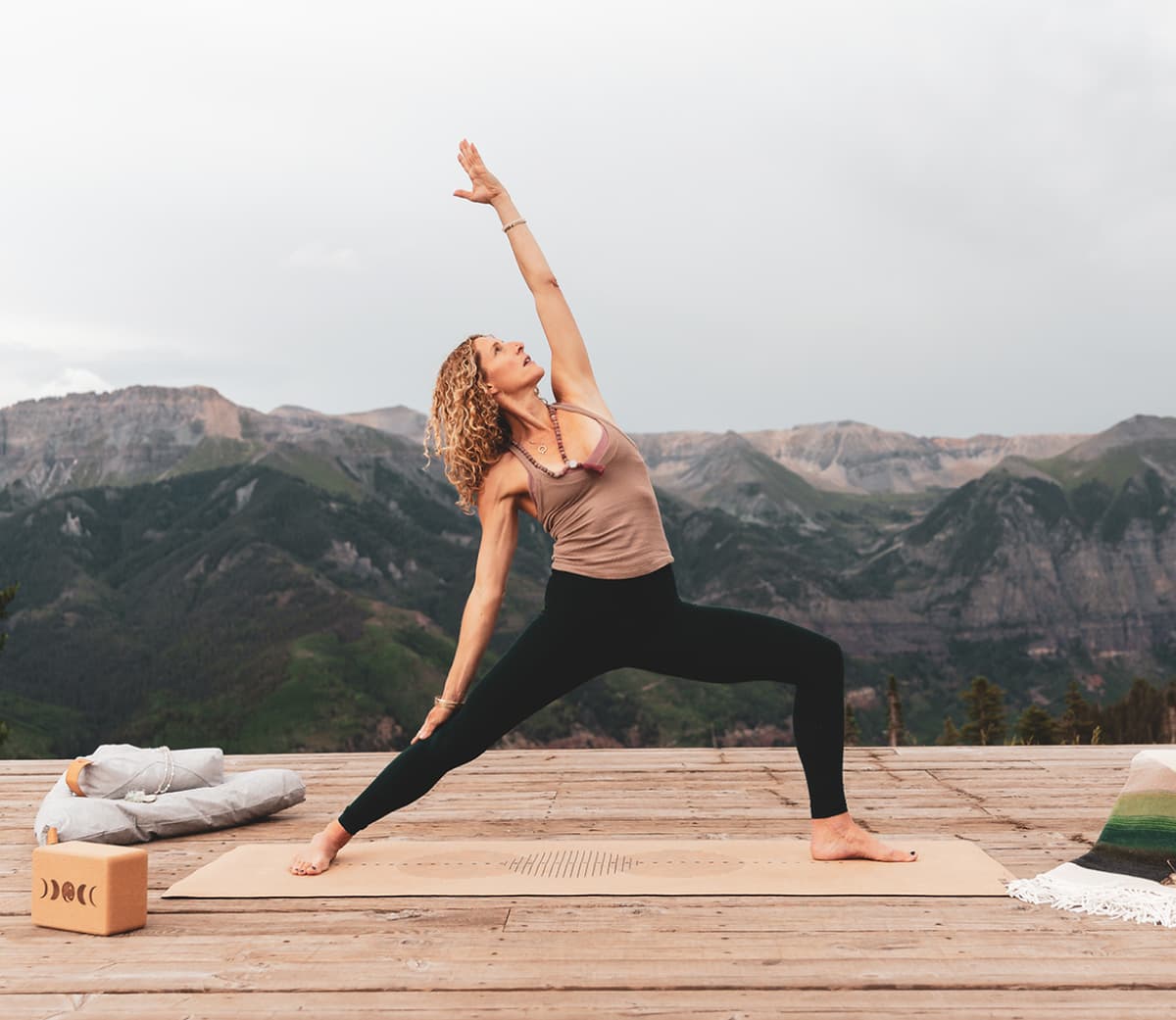 RESET photography showing a guest in a ypga pose with moutains in the background
